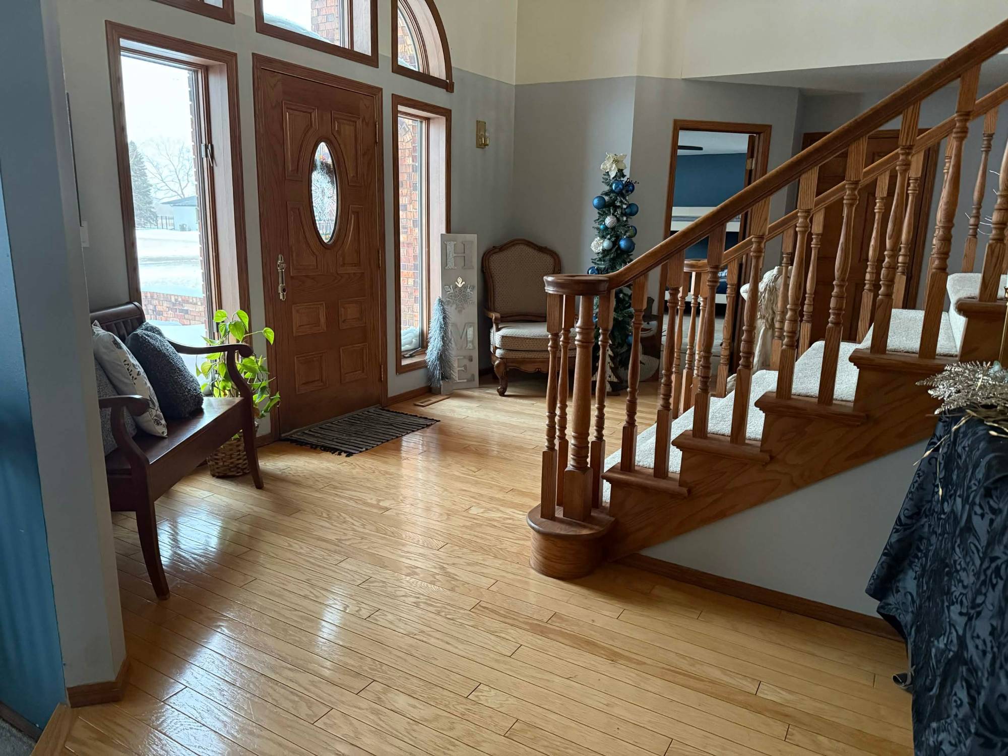 Foyer with oak staircase and hardwood floors