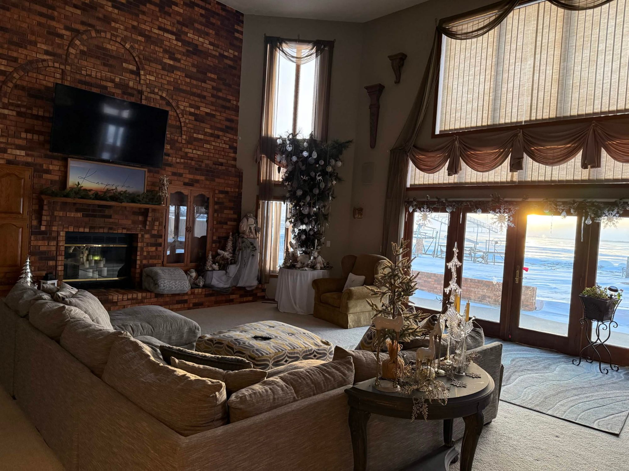 Great room with brick fireplace at winter sunrise