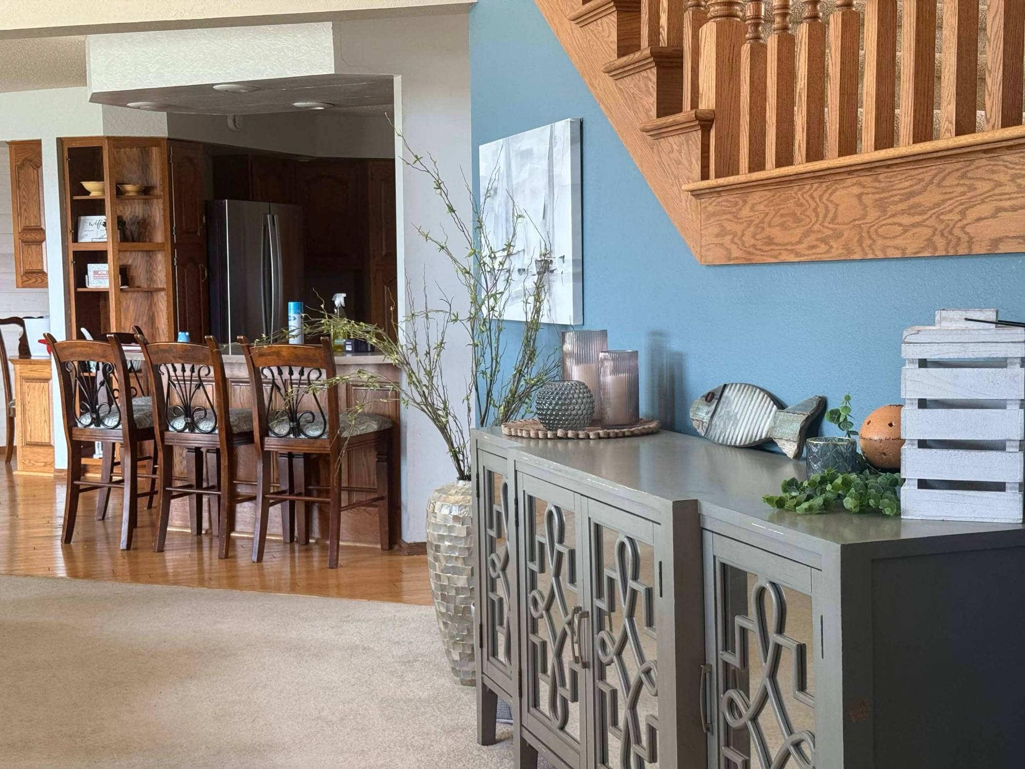 Sideboard below the stairs with the kitchen beyond
